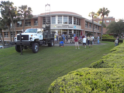 Photo of drill rig and visitors at FGS open house event